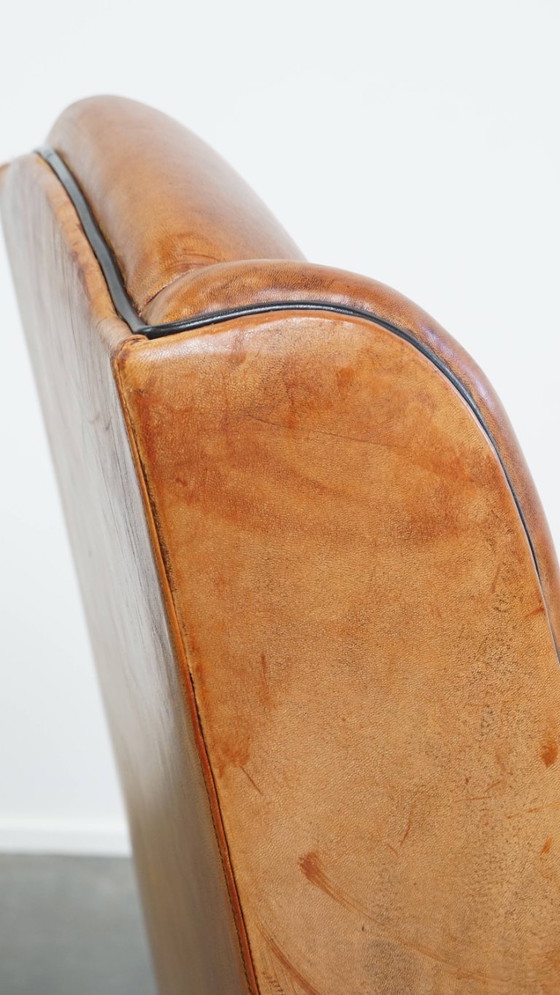 Image 1 of Schapenleren armchair met hoge rug en zwarte biezen 