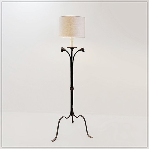 Wrought-iron tripod floor lamp adorned with stylized animal heads