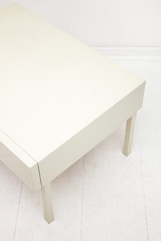 Image 1 of Mesita de noche de madera Interlübke con patas de metal lacado en blanco.