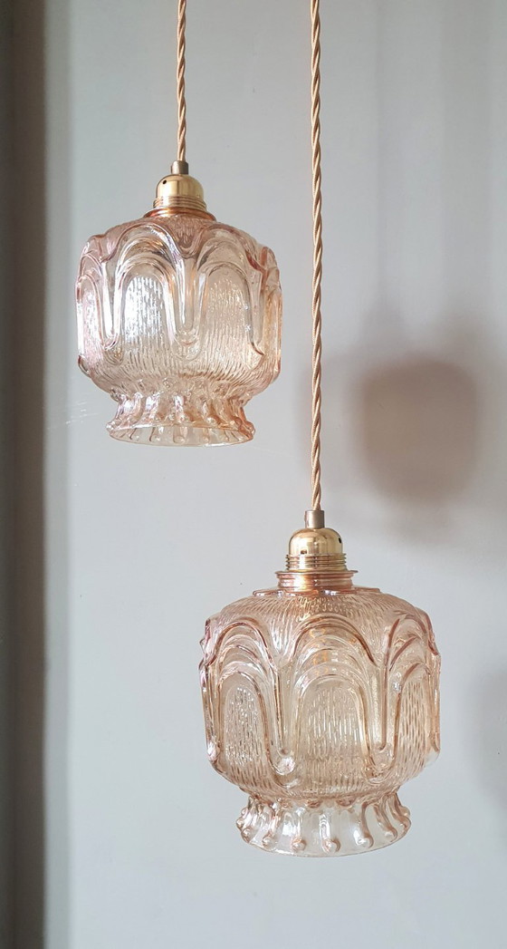 Image 1 of Set of 2 Vintage textured rose / amber tinted pendant lamps - mid-century design.
