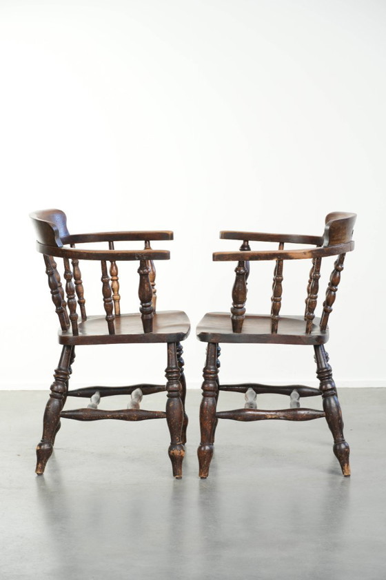 Image 1 of 2x antique English wooden pub/captain chairs from the late 19th century with character and a beautiful color scheme