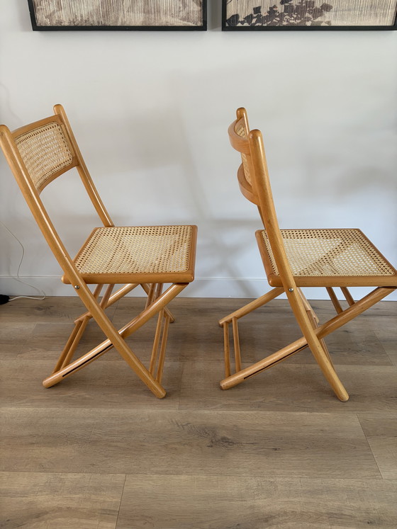 Image 1 of Twee vintage inklapbare houten met webbing stoelen 