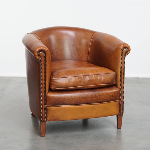 In good condition club chair made of sheep leather