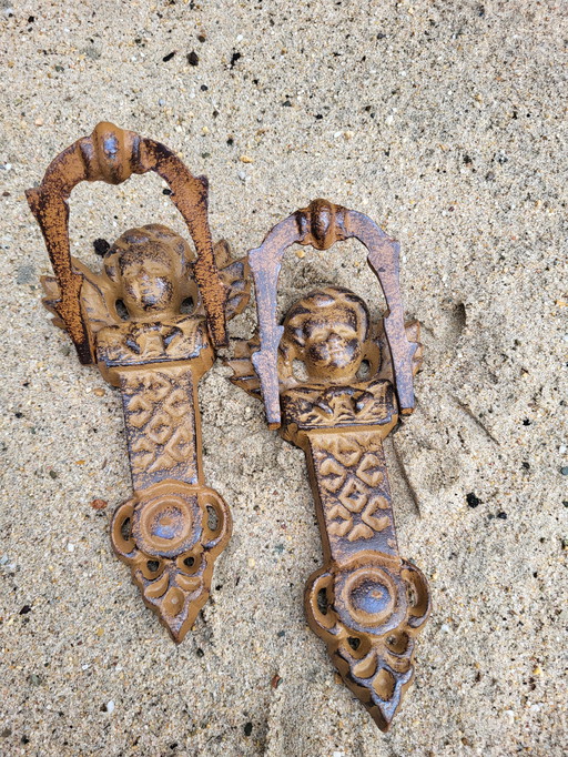 2 cast iron door knockers shaped like angels