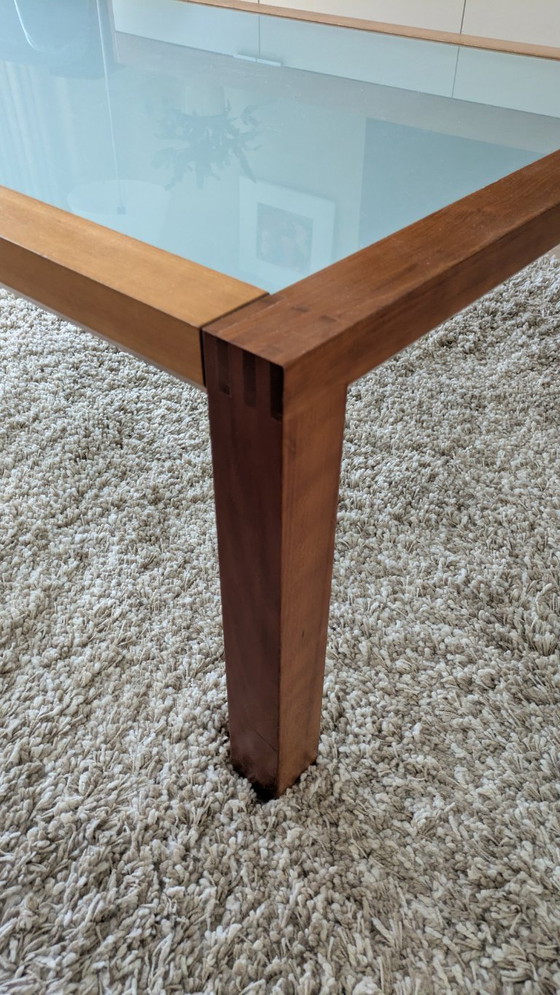 Image 1 of cherry wood red coffee table with sleek glass top from 1996