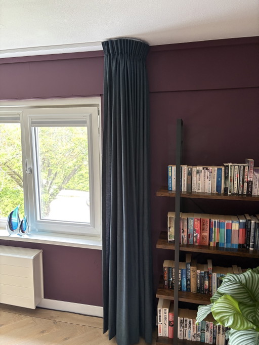 Floor-to-ceiling dark blue curtains