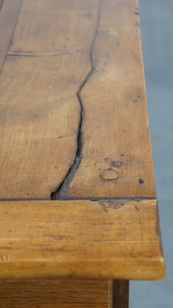 Image 1 of Large antique French farmhouse dining table made of fruitwood from the late 18th century with beautiful and original details.