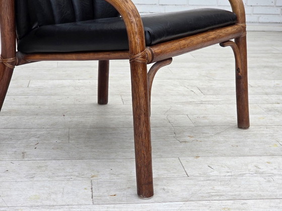 Image 1 of 1970s, Danish armchair, rattan, black artificial leather.