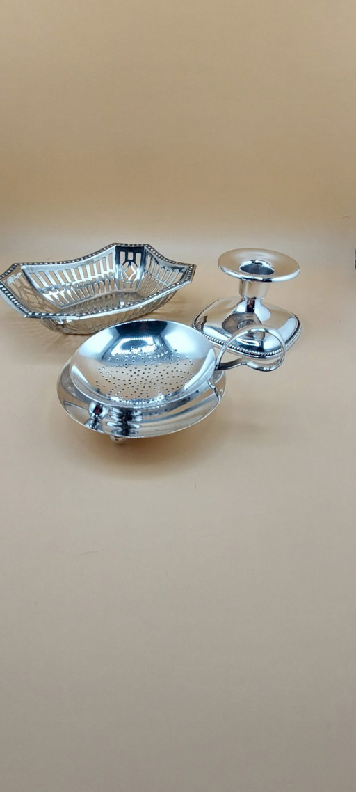 Lot of silver-plated items including candlestick, small bowl, tea strainer