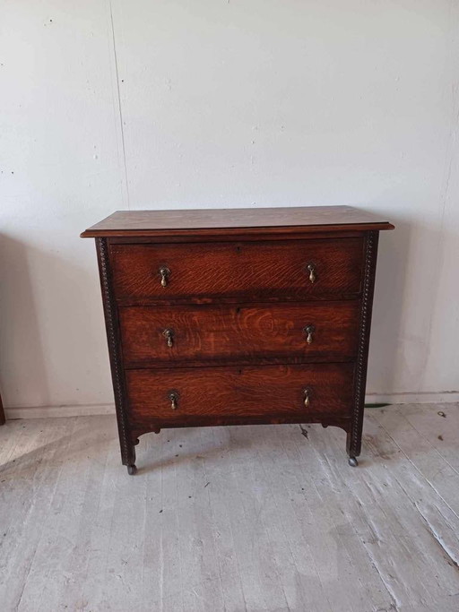 Antique Oak Chest of Drawers on Castors with Brass Handles and Carved Details