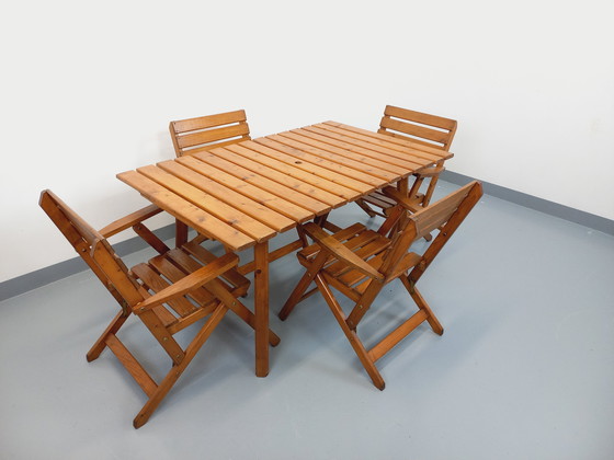 Image 1 of Vintage garden furniture consisting of a table with extensions and 4 wooden armchairs from the 60s