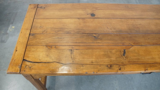 Image 1 of Large antique French farmhouse dining table made of fruitwood from the late 18th century with beautiful and original details.