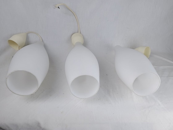 Image 1 of Elegant and timeless, this set of three original Holmegaard glass pendant lamps