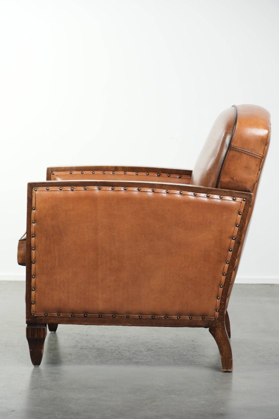 Image 1 of Unieke schapenleren art Deco fauteuil met mooi houtsnijwerk en zwarte biezen