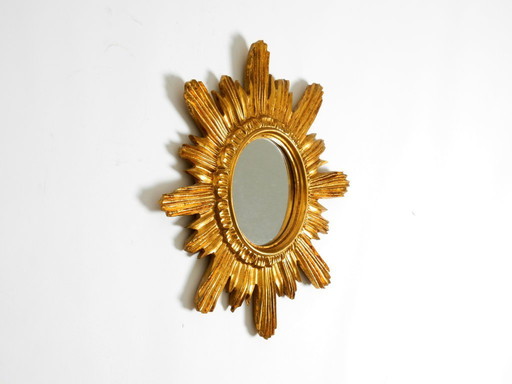 Beautiful Italian Mid Century Sunburst wall mirror made of wood and resin, gold-plated