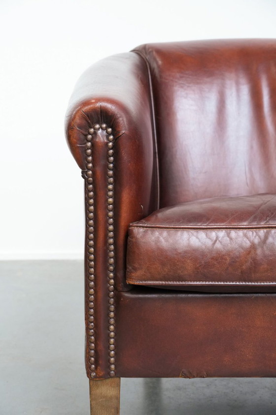 Image 1 of Vintage clubfauteuil gemaakt van schapenleer met siernagels