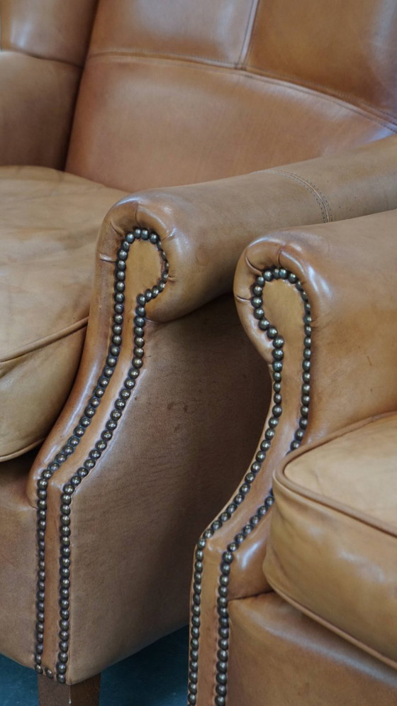 Image 1 of 2x Rundleren oorfauteuil afgewerkt met siernagels