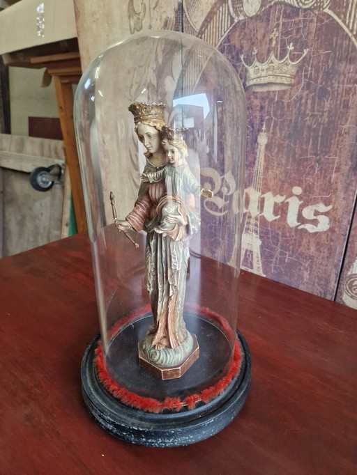 Antique bell jar with statue of Mary