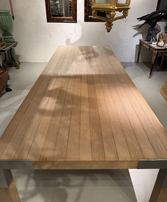 Image 1 of A large oak dining table, designed by Claire Bataille and Paul Ibens
