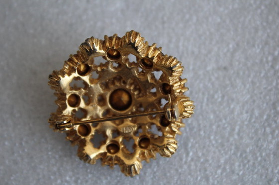 Image 1 of Vintage costume jewelry brooch with amber rhinestones, marked SPHINX