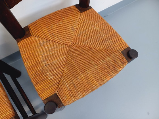Image 1 of Set van 4 vintage brutalistische stoelen van Georges Robert, gemaakt van hout en stro, uit de jaren 50 en 60.