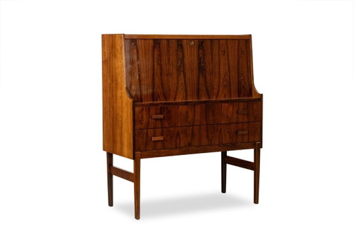 Commode van palissanderhout met 2 laden, die tevens als secretair dient. Jaren 70.