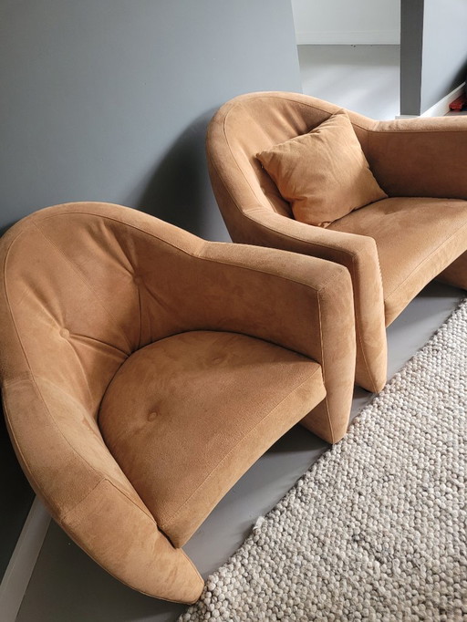 Two Leolux armchairs (Carabas model), one footstool, and three cushions. Upholstery: Alcantara.