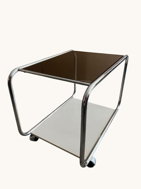 Image 1 of Vintage Space Age side table made of chrome and smoked glass. Sculptural 70s design with wheels.