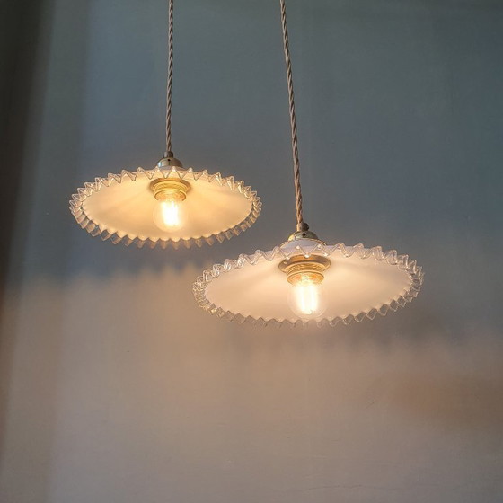 Image 1 of 2 vintage hanglampen van wit opaline glas met een transparante sierrand.