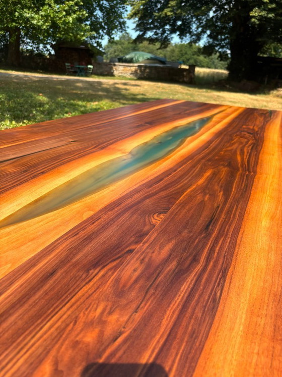 Image 1 of Dining table in American walnut and maple. Handcrafted solid wood extensions and drawers. Live edge for visual depth. Epoxy resi