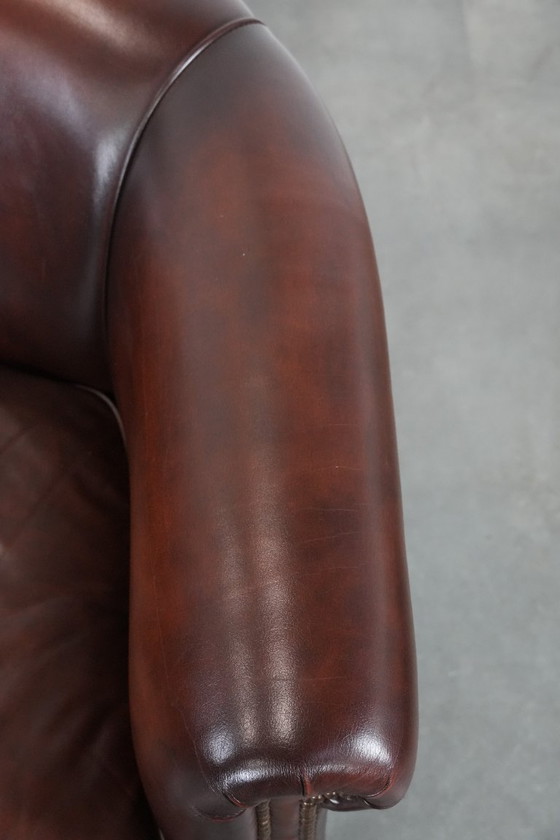 Image 1 of Sillón club de piel de vaca en buen estado, de un lujoso color rojo/marrón.