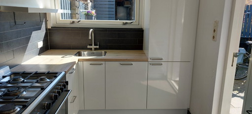 Complete kitchen including built-in appliances and freestanding stove