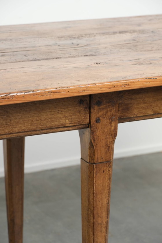 Image 1 of Large, relatively narrow antique French farmhouse dining table made of pine from the early 19th century with a beautiful patina.