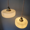 Ensemble de deux suspensions vintage en verre opalin jaune pastel. Design Art Déco.