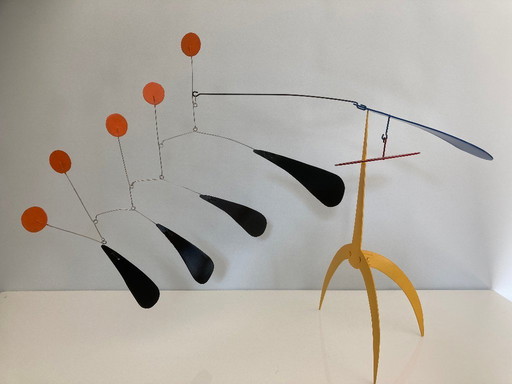 Yellow standing mobile with 5 orange discs