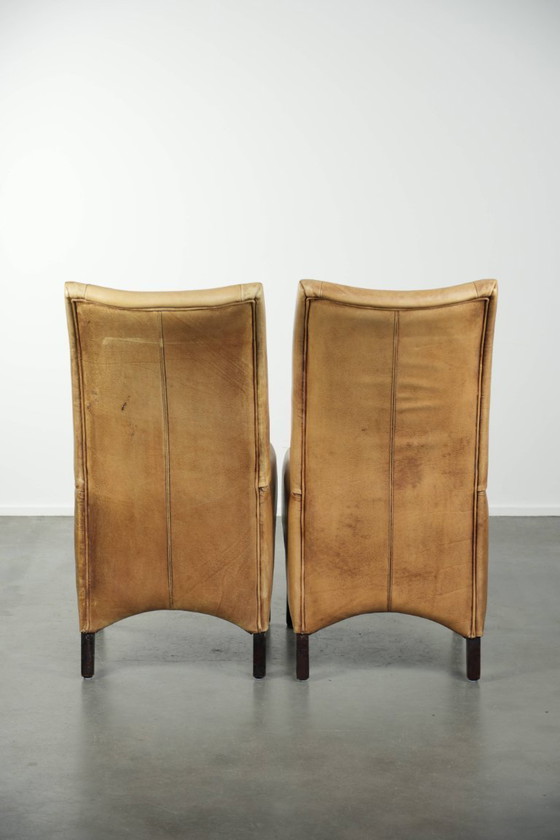 Image 1 of 6 chaises de salle à manger en cuir de vachette clair, avec une belle couleur claire, une assise confortable et un dossier haut.