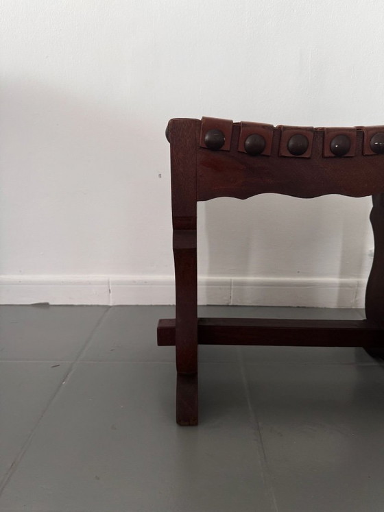 Image 1 of Tabouret espagnol à assise en cuir tressé, piètement à tréteaux et motifs ajourés