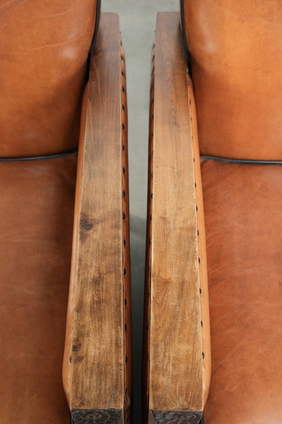 Image 1 of 2 x Prachtige schapenleren Art Deco fauteuil met mooi houtsnijwerk en zwarte biezen