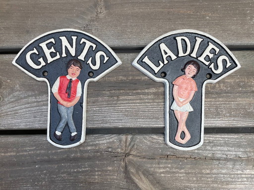 Set of two nostalgic cast iron toilet signs
