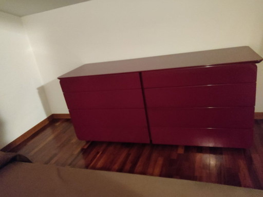 Burgundy red chest of drawers and two bedside tables