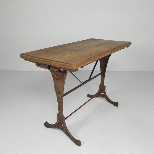 Art Deco bistro table with oak top on cast iron frame