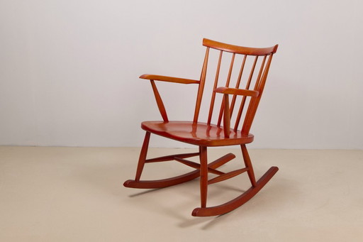 Red stained beech rocking chair, 1960's