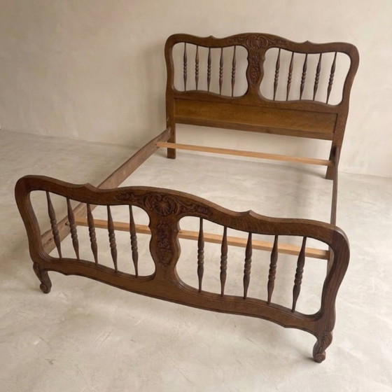 Image 1 of Vintage houten bedframe met houtsnijwerk, sierlijk hoofd- en voetbord, eerste helft 20e eeuw