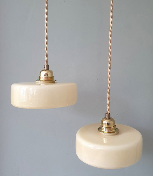 Vintage pendant lamp set (2) of yellow pastel opaline glass. Art Deco design.