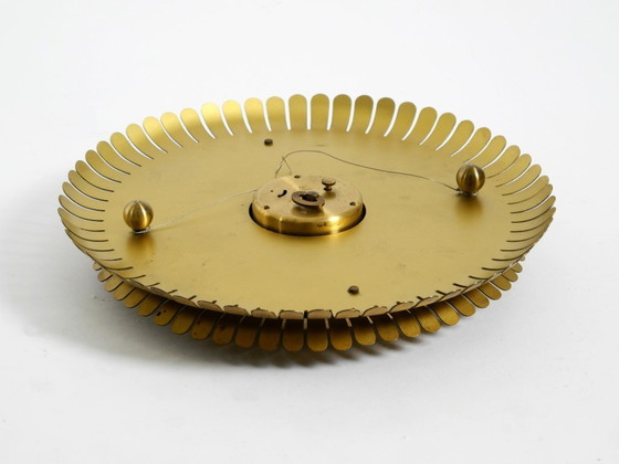 Image 1 of Beautiful original Mid Century Sunburst Atlanta Universe wall clock made of heavy brass with a mechanical seven-day movement