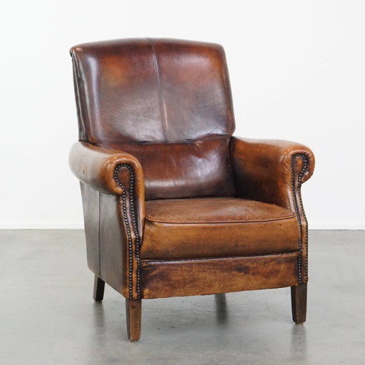 Vintage sheep leather armchair with a high back