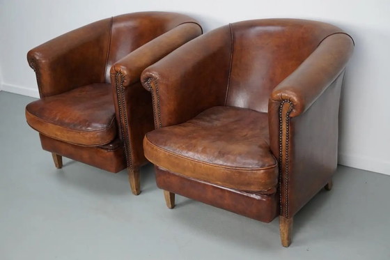 Image 1 of Vintage Nederlandse leren clubfauteuils in cognackleur, set van 2 met voetenbank
