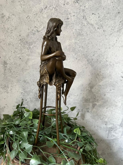 Bronze lady on chair