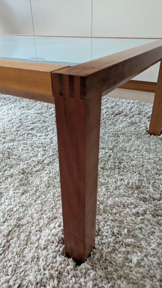 Image 1 of cherry wood red coffee table with sleek glass top from 1996
