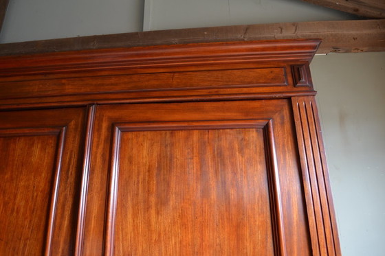 Image 1 of Sleek antique mahogany cabinet.